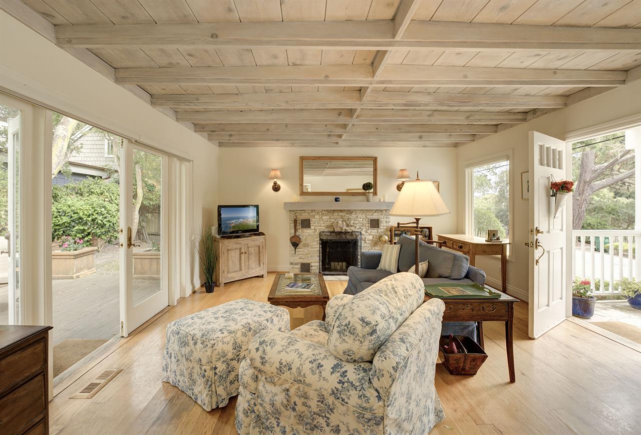 Living Room has Wood Floors and Exposed Beamed Ceilings