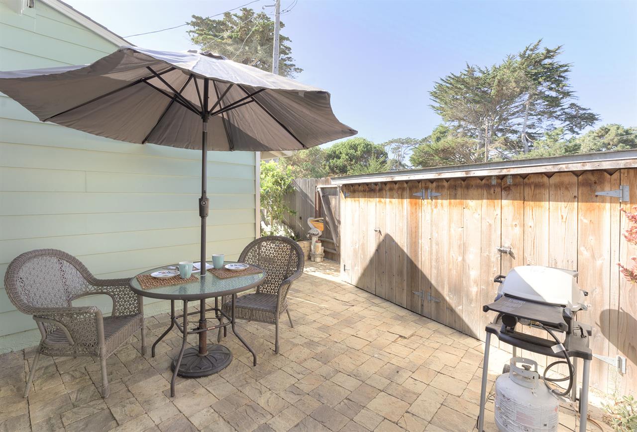 Backyard has a Gas Grill and Dining Area