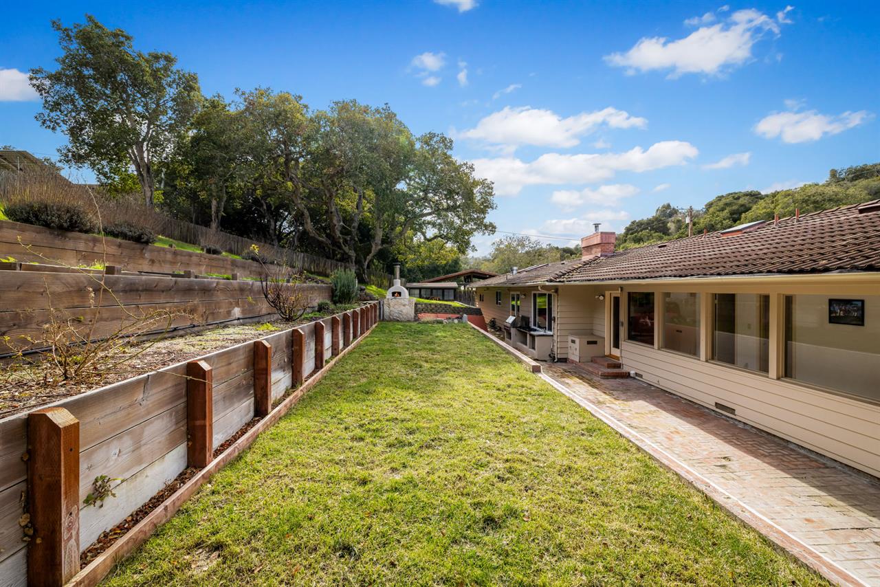 Backyard Showing the Tiered Planting Area, Patio and Pizza Oven