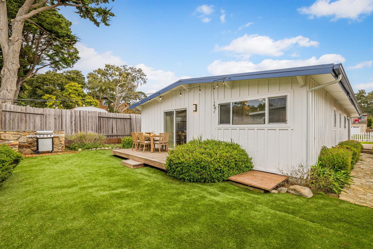 Backyard has a Gas Grill and Dining Area