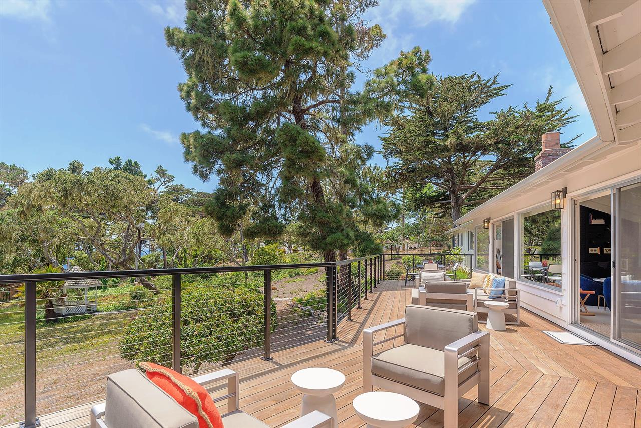 Outdoor Living and Dining Deck Overlooks the Backyard