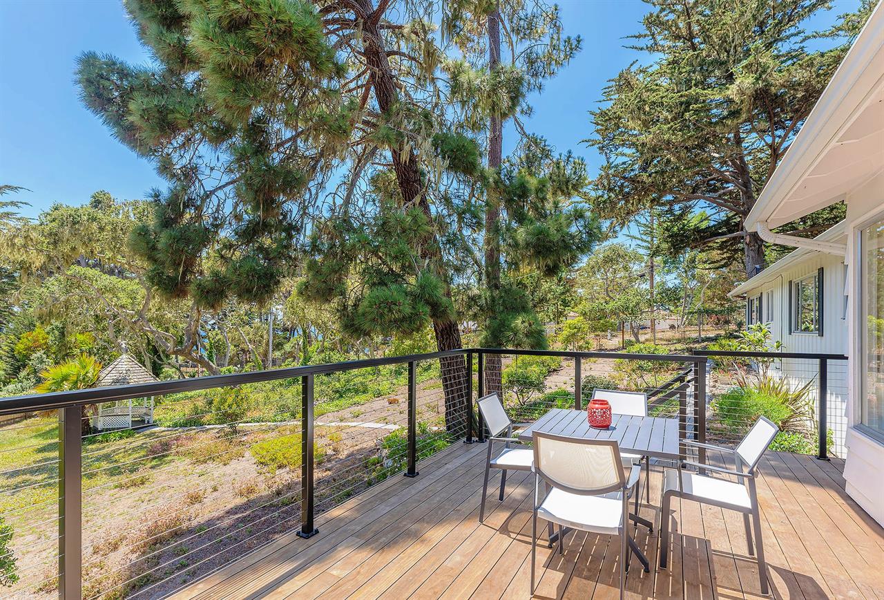 Outdoor Living and Dining Deck Overlooks the Backyard