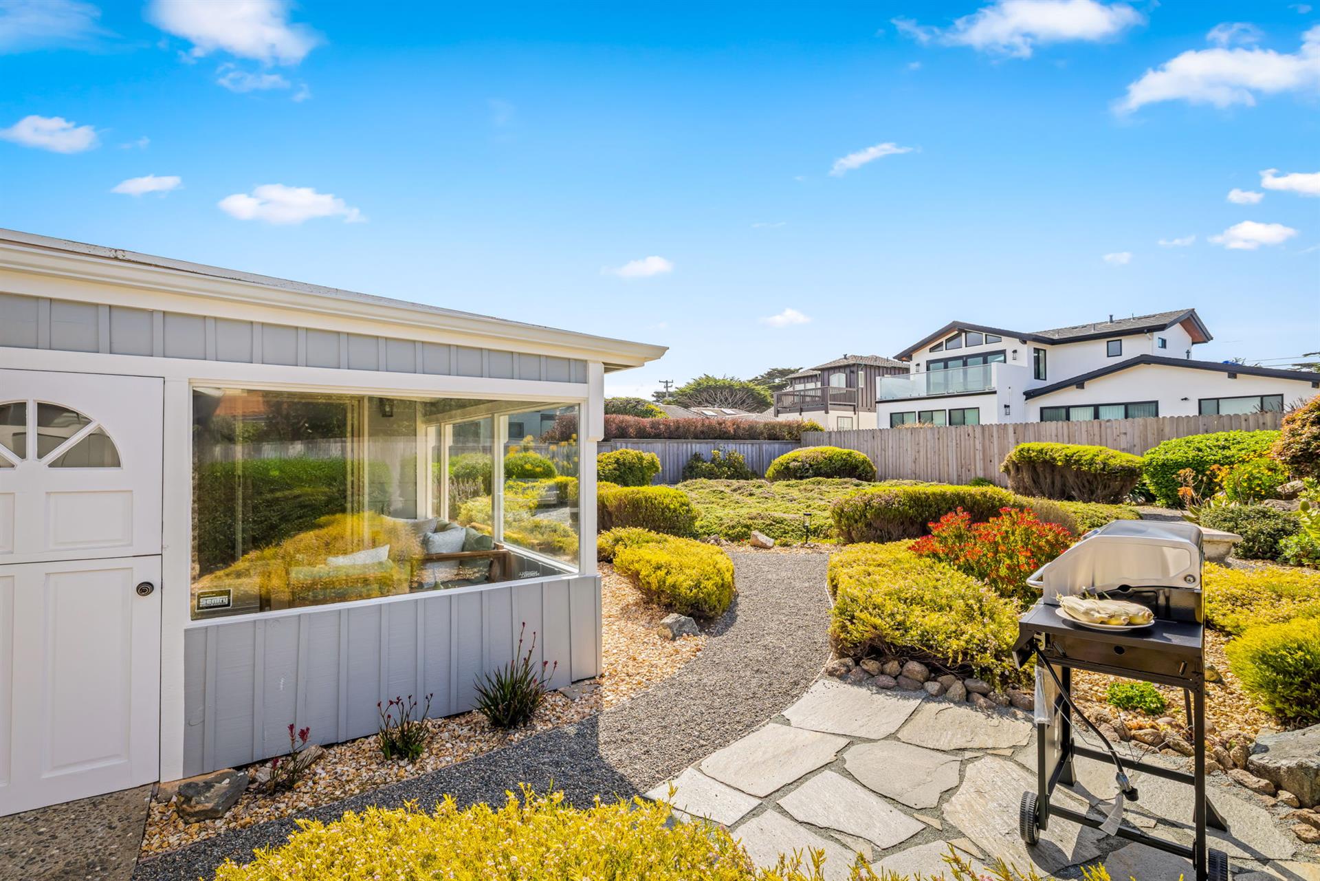 The Spacious, Fenced Backyard has a Gas BBQ Grill