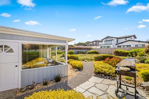 The Spacious, Fenced Backyard has a Gas BBQ Grill