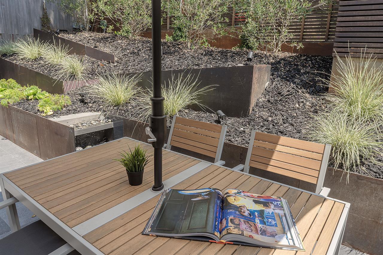 Front Courtyard Patio with Dining Table and Water Feature