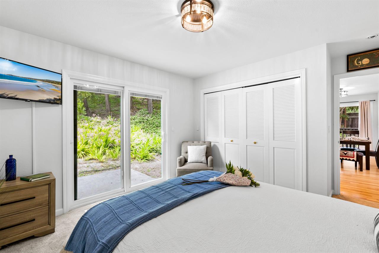 Downstairs Bedroom 3  Queen Bed, TV and Backyard Access