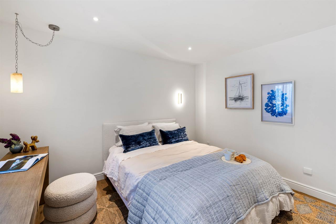 Bedroom 2 has a Queen Bed and a Desk