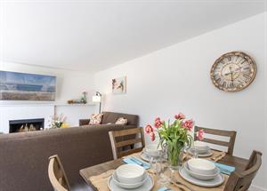 Living Room has a Gas Fireplace, TV and Dining for Four