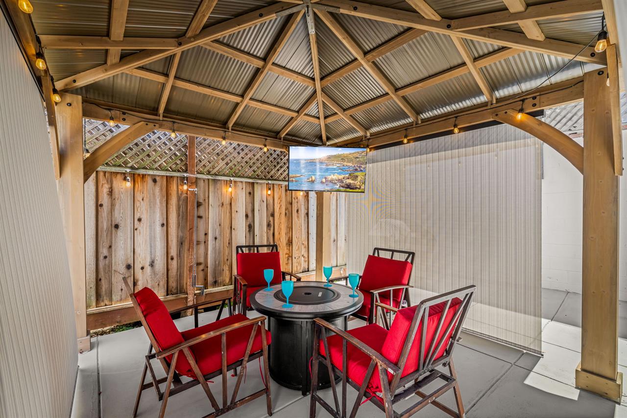 Backyard has a Gas Grill, Fire Pit Table and TV