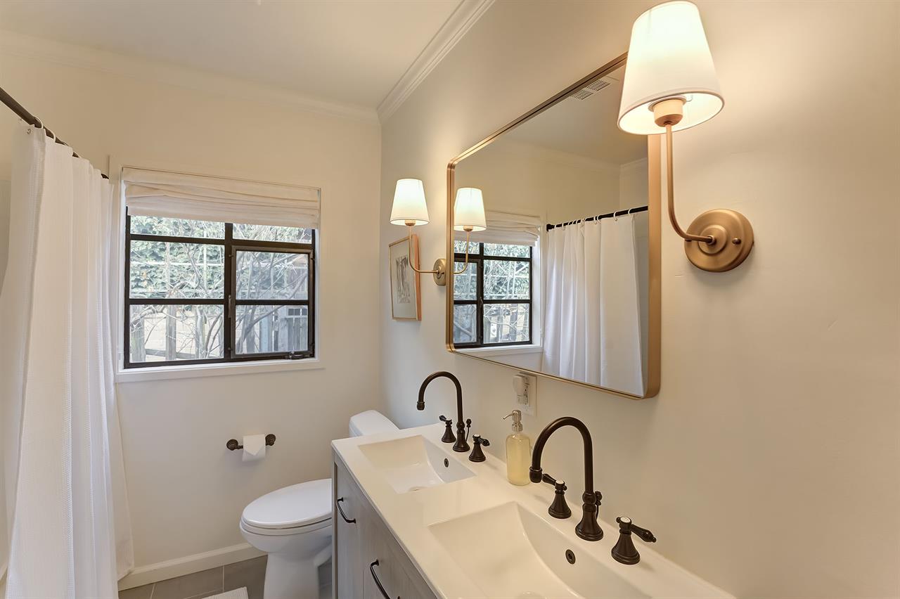 Bathroom has Two Sinks and a ShowerOverTub Combo