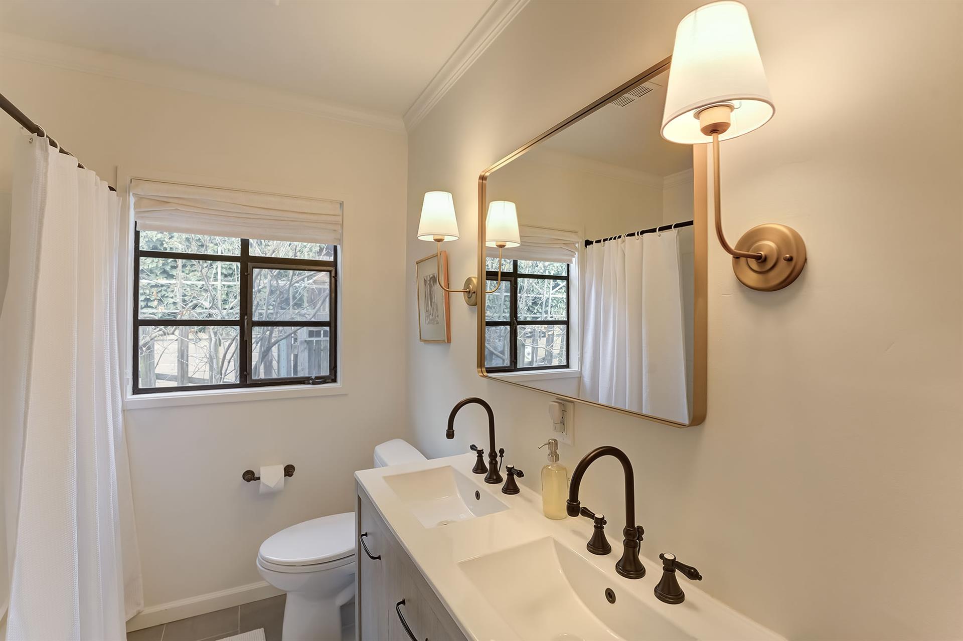 Bathroom has Two Sinks and a ShowerOverTub Combo