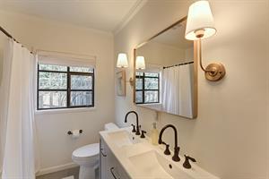 Bathroom has Two Sinks and a ShowerOverTub Combo