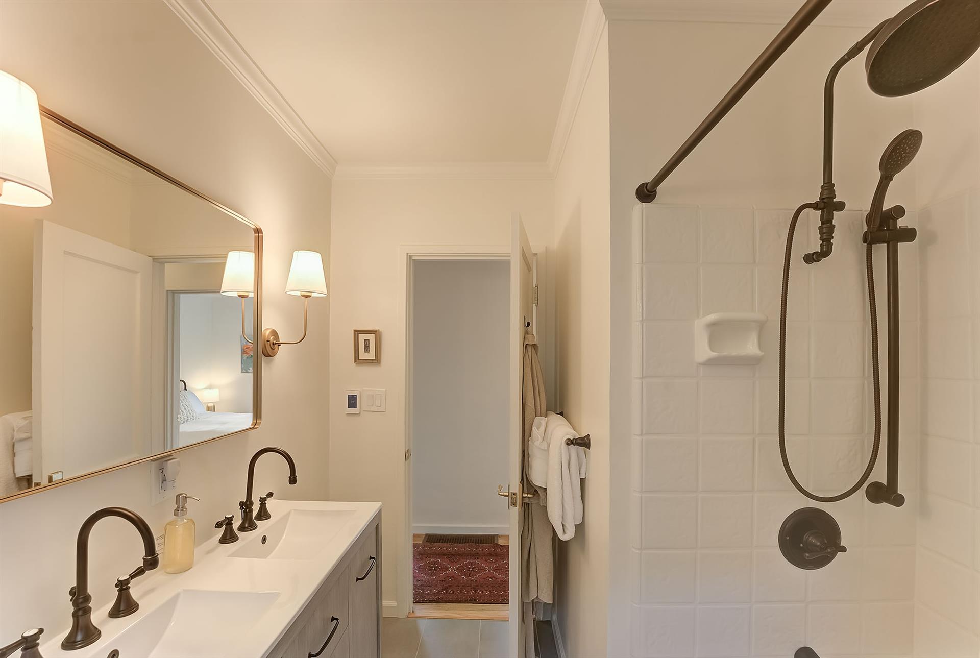 Bathroom has Two Sinks and a ShowerOverTub Combo