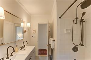 Bathroom has Two Sinks and a ShowerOverTub Combo