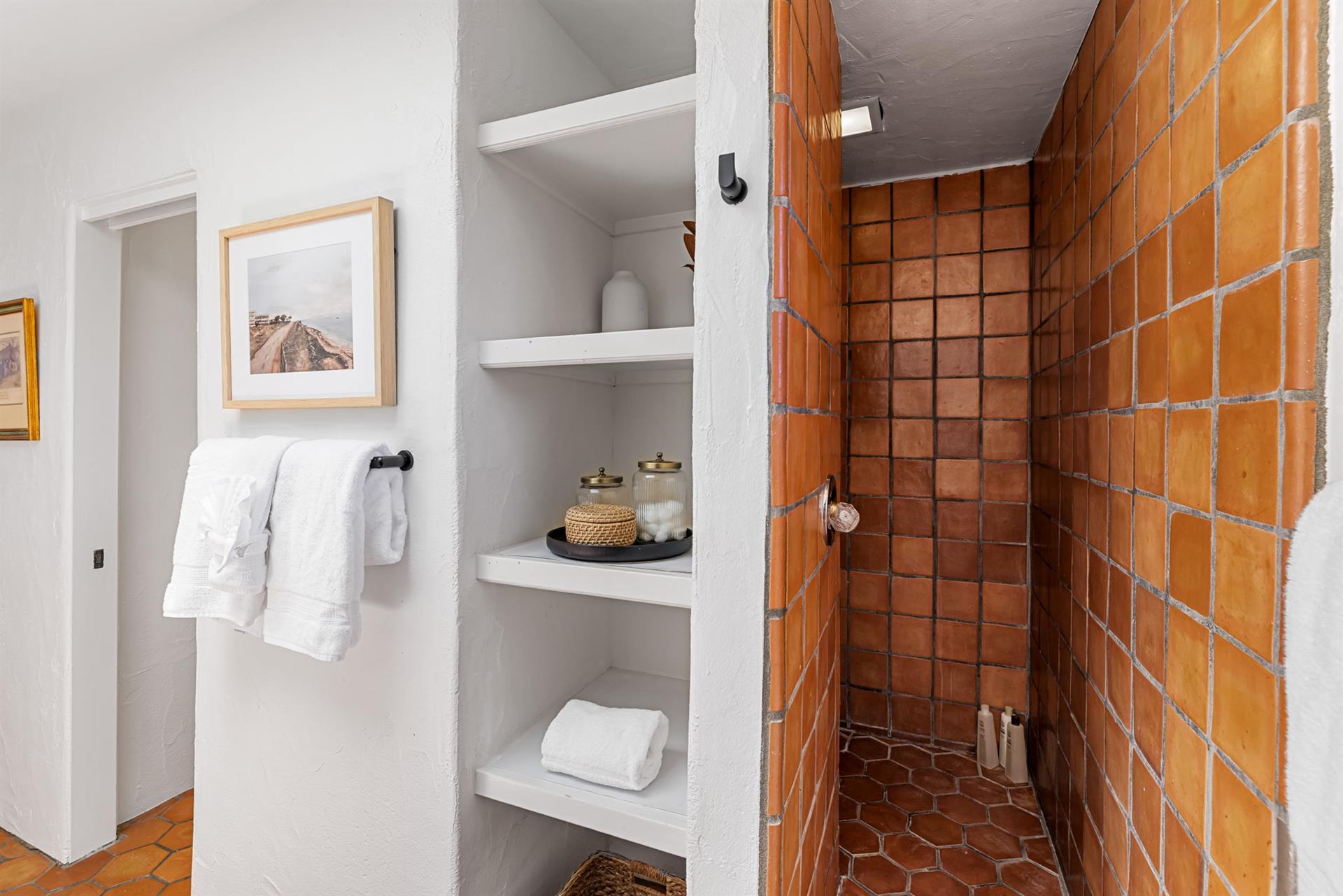 Bedroom 1 Bathroom has a Terra Cota Tiled Shower