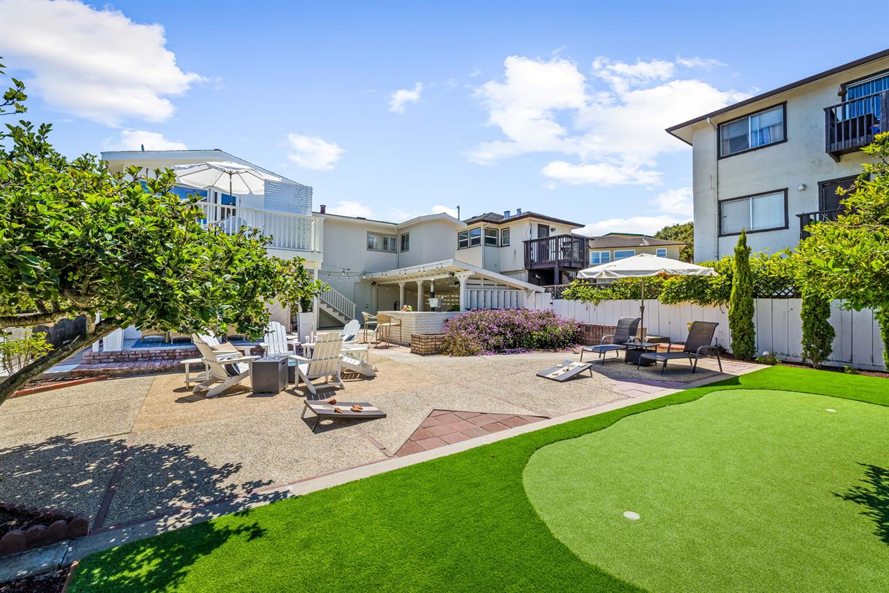 Fenced Backyard has two covered seating areas, string lights....