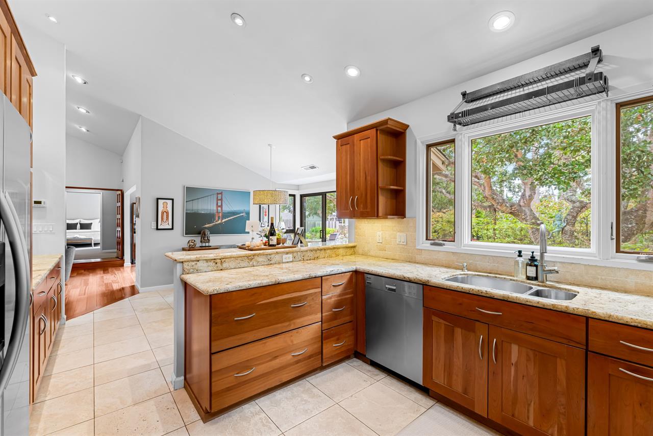 Chefs Kitchen with Granite Counters and Back Yard View