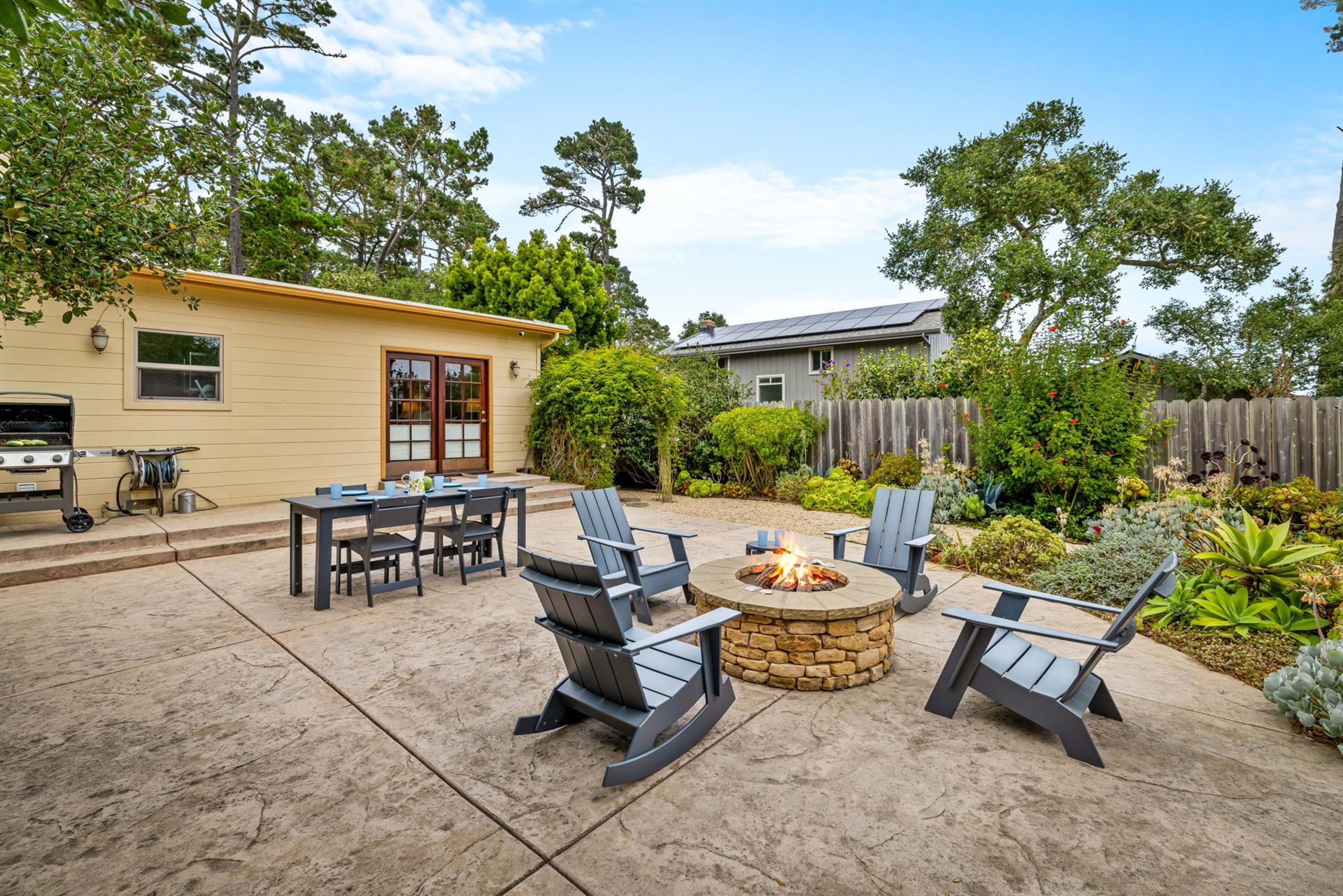 Back Yard has a Gas Grill, Dining Area and Firepit