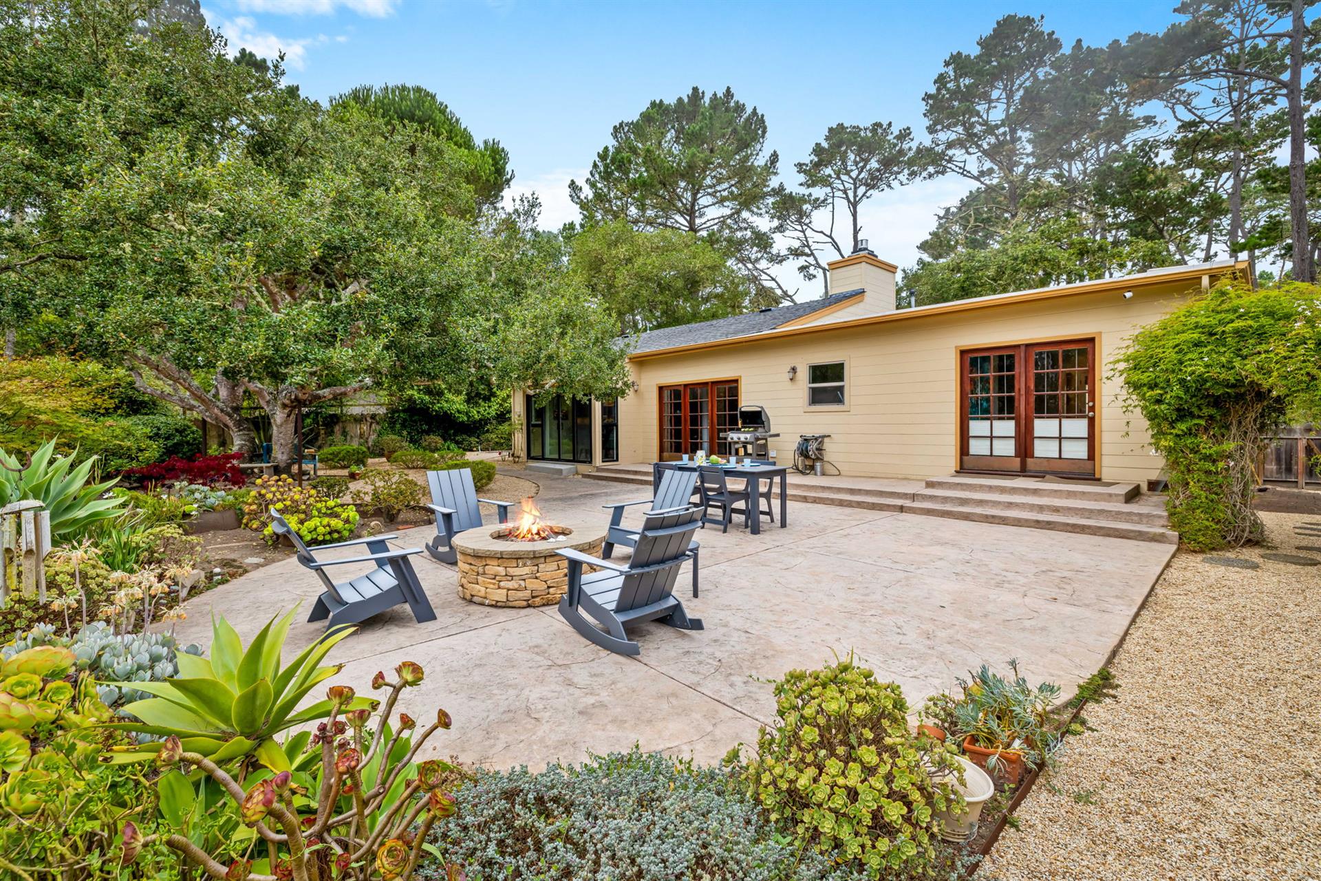 Backyard has a Gas Grill, Dining Area and Firepit