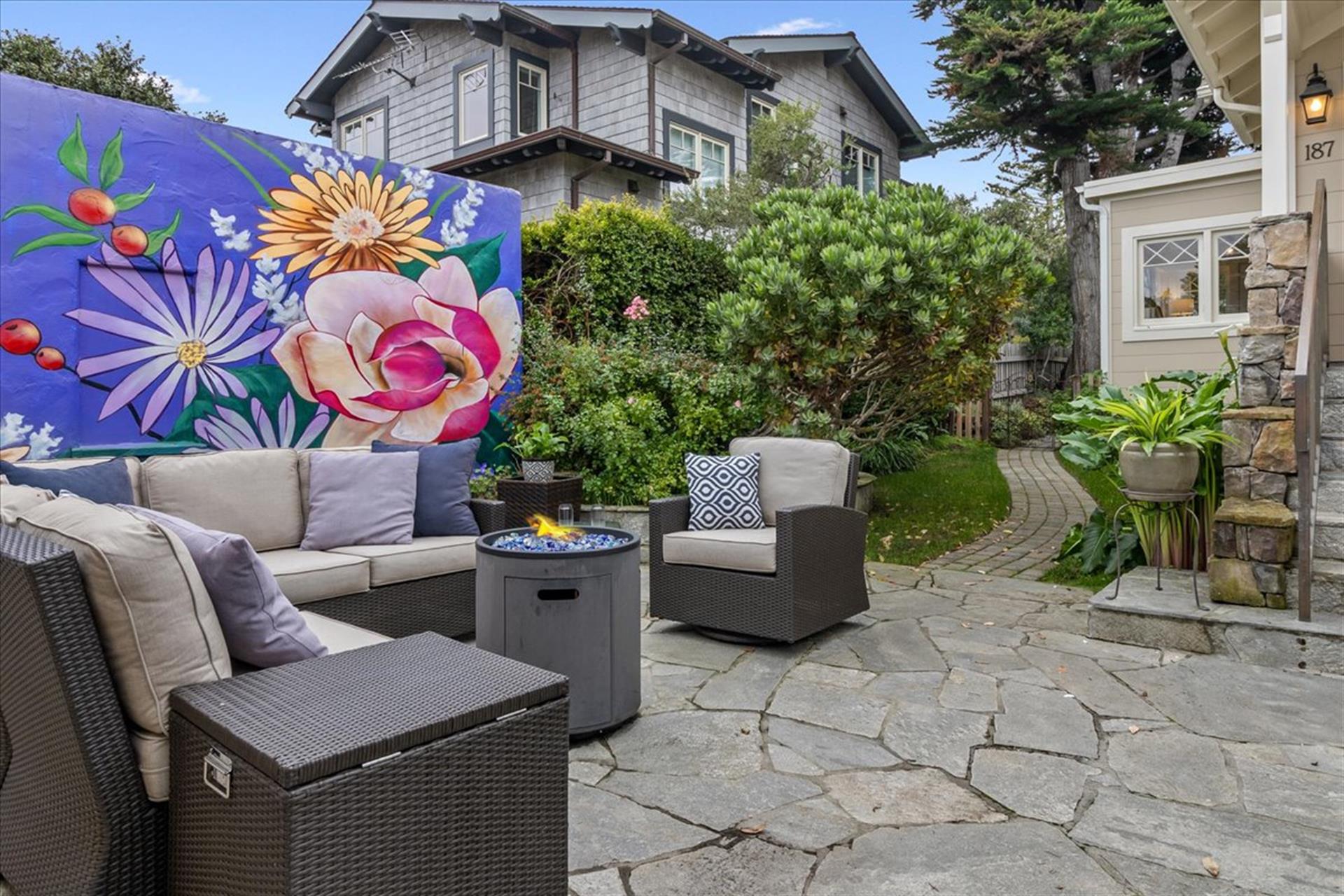 Backyard has a Lounging Area with a Fire Pit