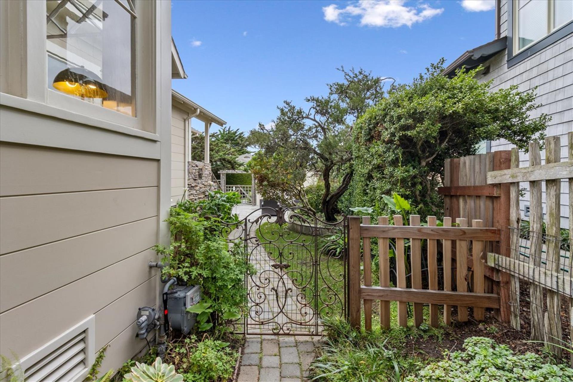 Artistic Iron Gate Leads from the Backyard to the Front Yard