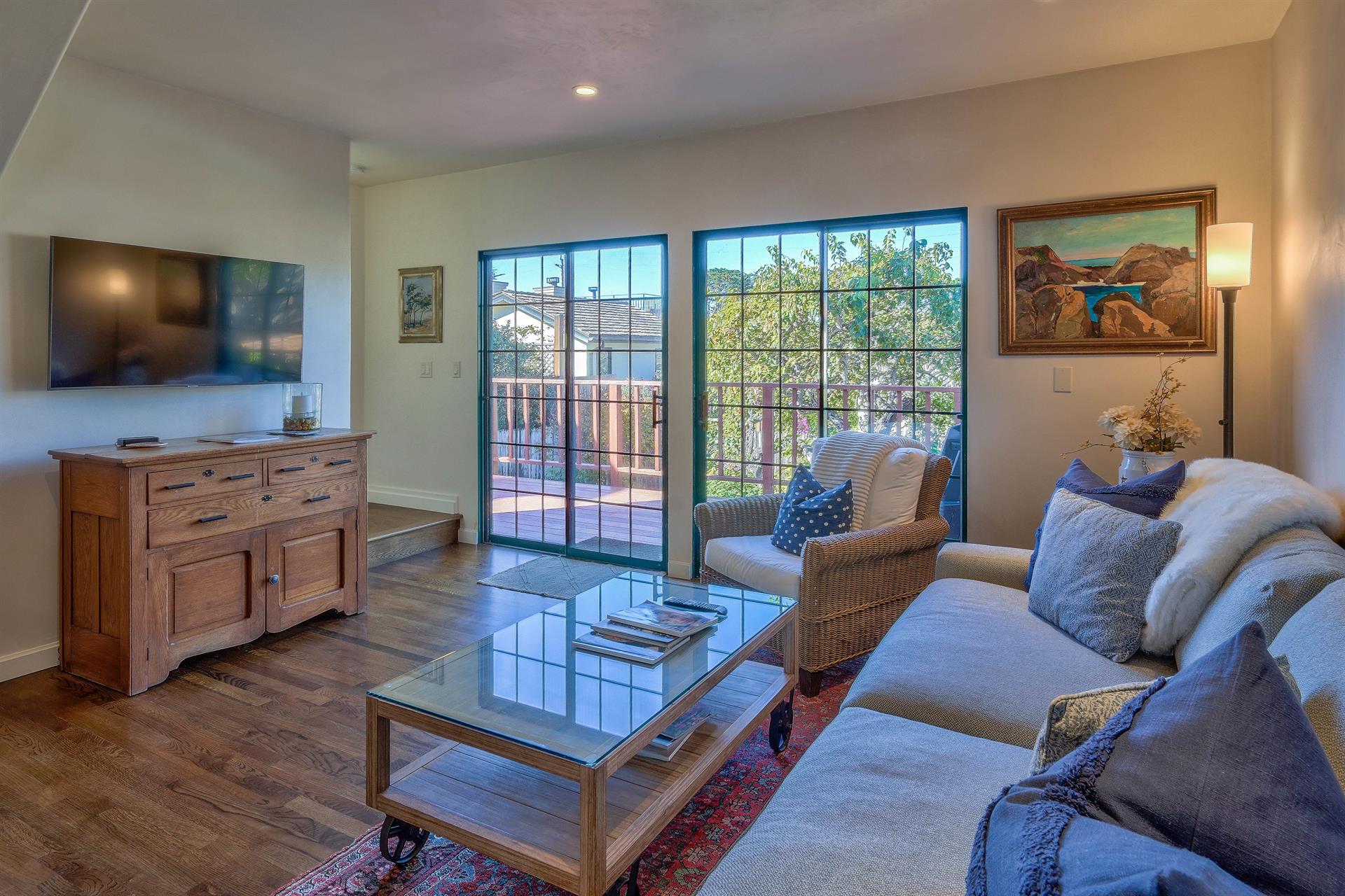 Family Room has a TV and Sliding Doors to a Back Deck