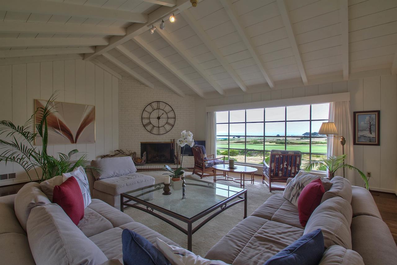 Living Room with Wood Burning Fireplace and TV