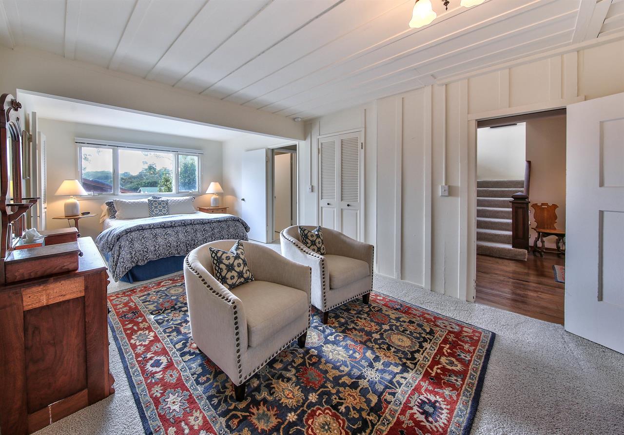 Downstairs Bedroom 1 has a King Bed, Sitting Area and TV