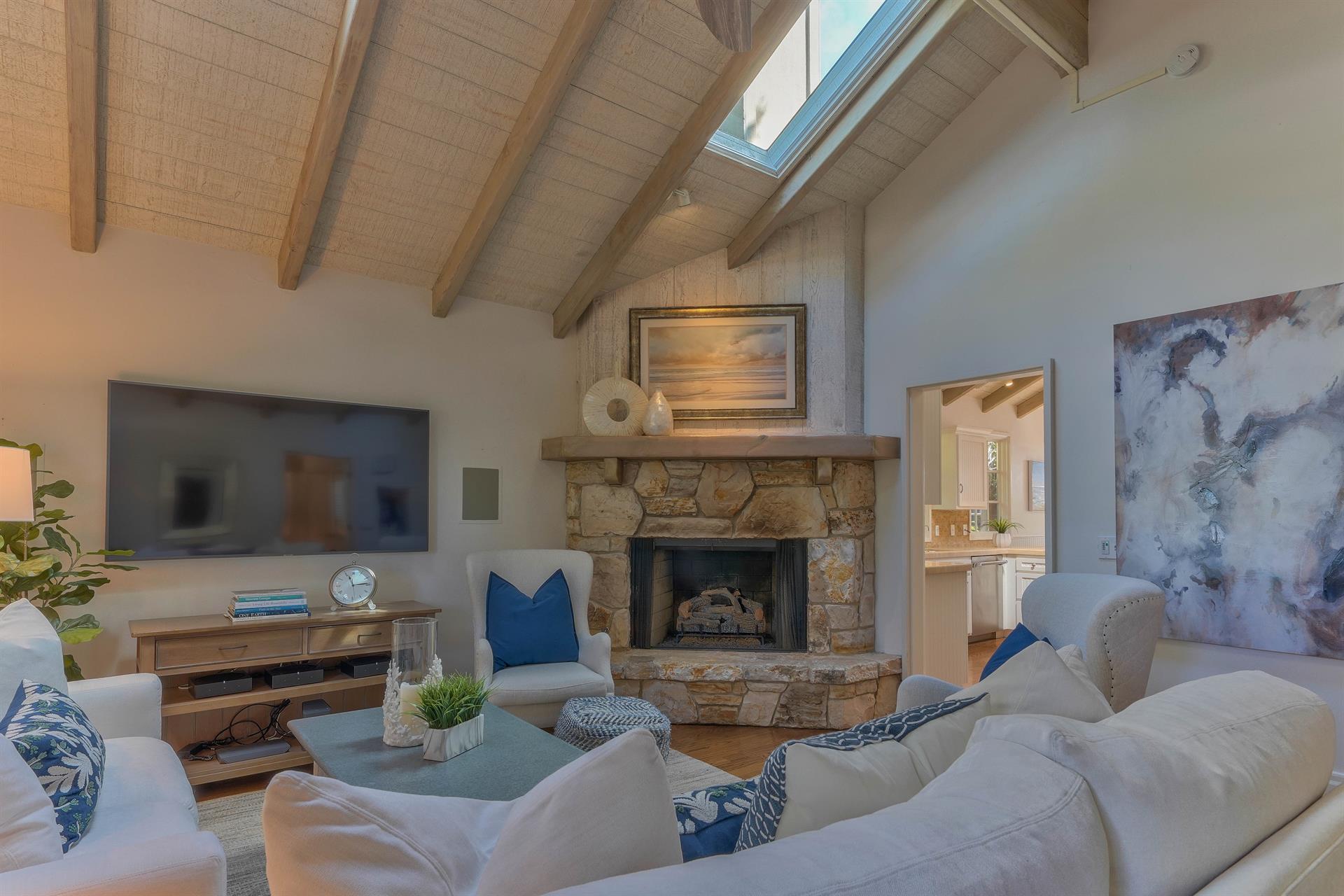 Gas Log Fireplace and a Large Screen Wall Mounted Smart TV