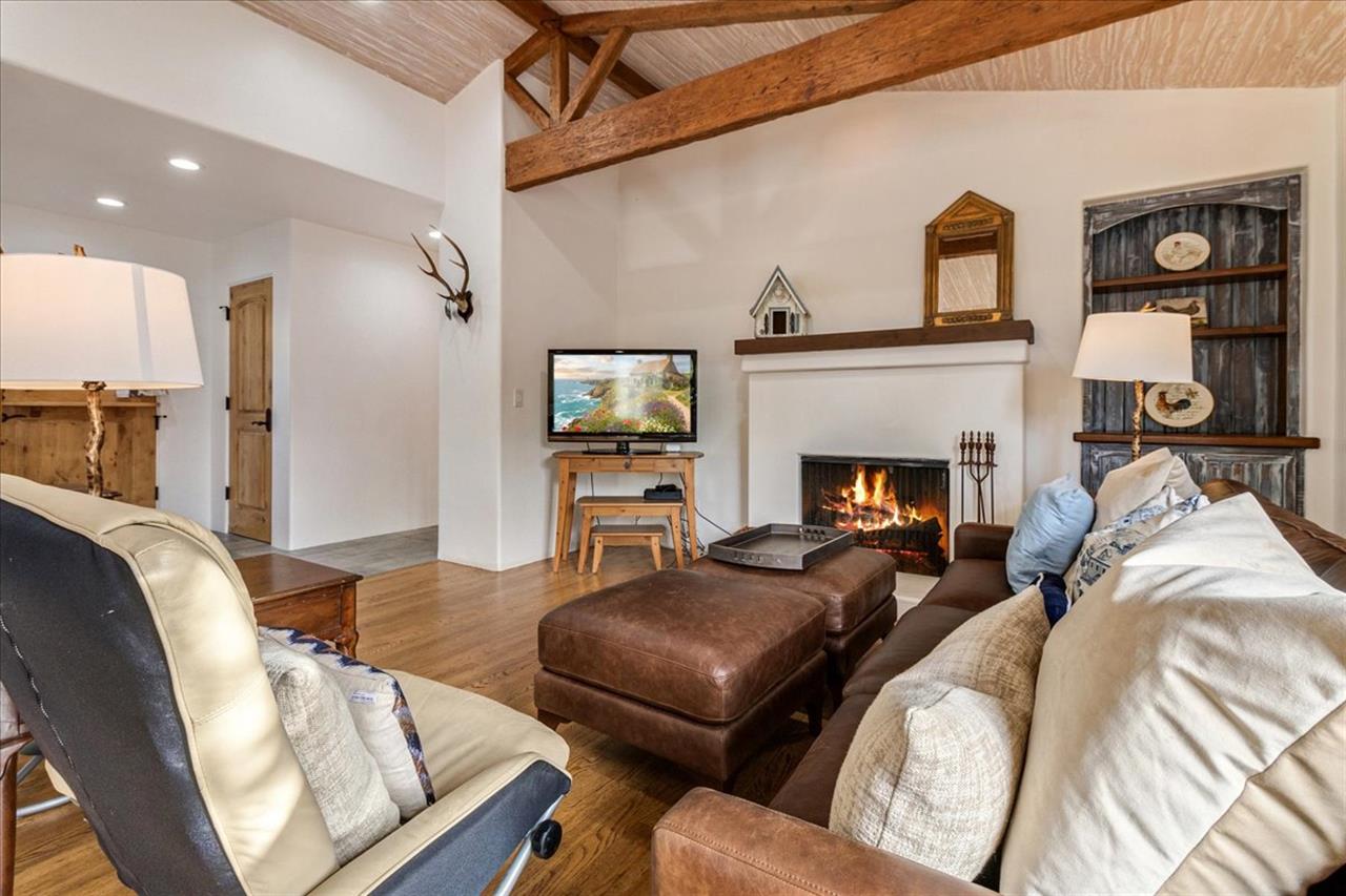 Living Room has a WoodBurning Fireplace and TV