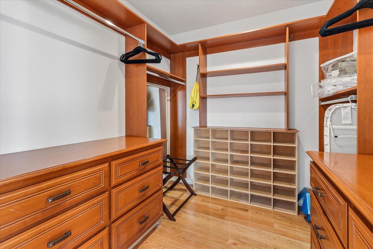 Spacious WalkIn Closet with BuiltIn Dresser for Bedroom 1