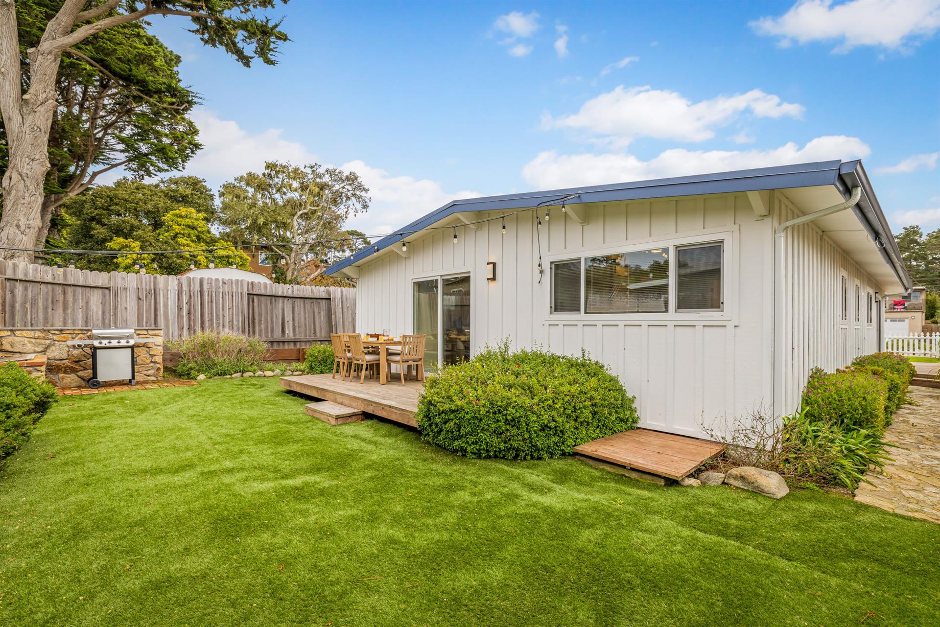 Backyard has a Gas Grill and Dining Area