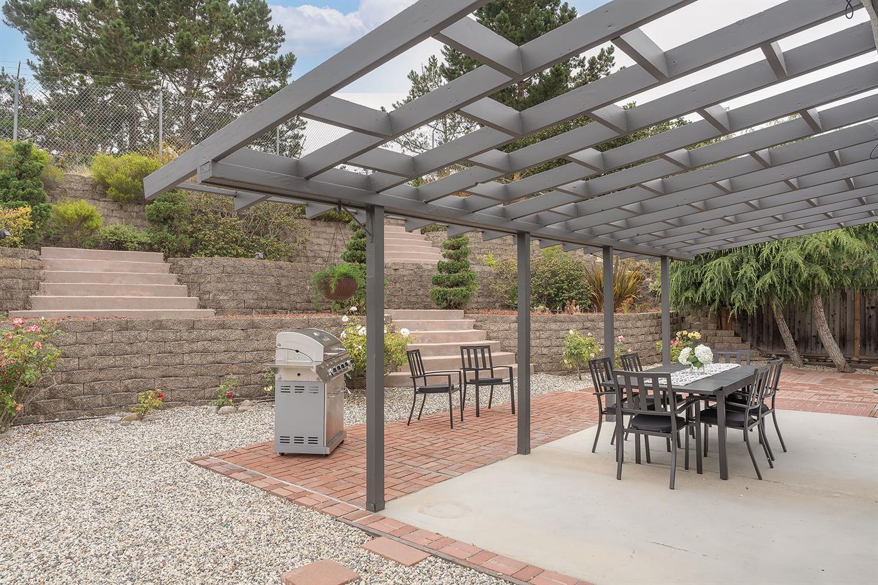 Backyard has a Gas Grill and Dining Area