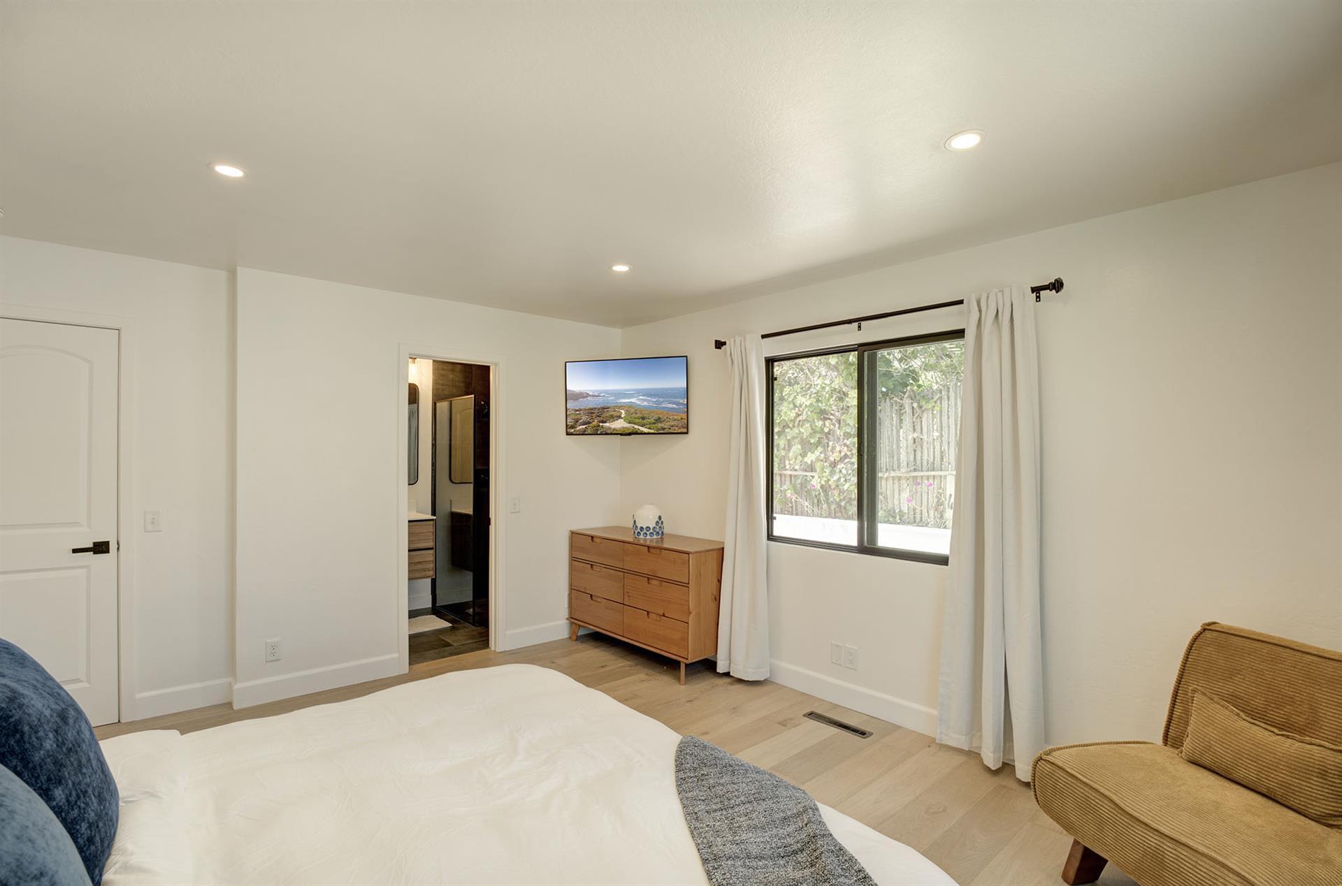 Bedroom 1 has a King Bed and EnSuite Bath with a Shower