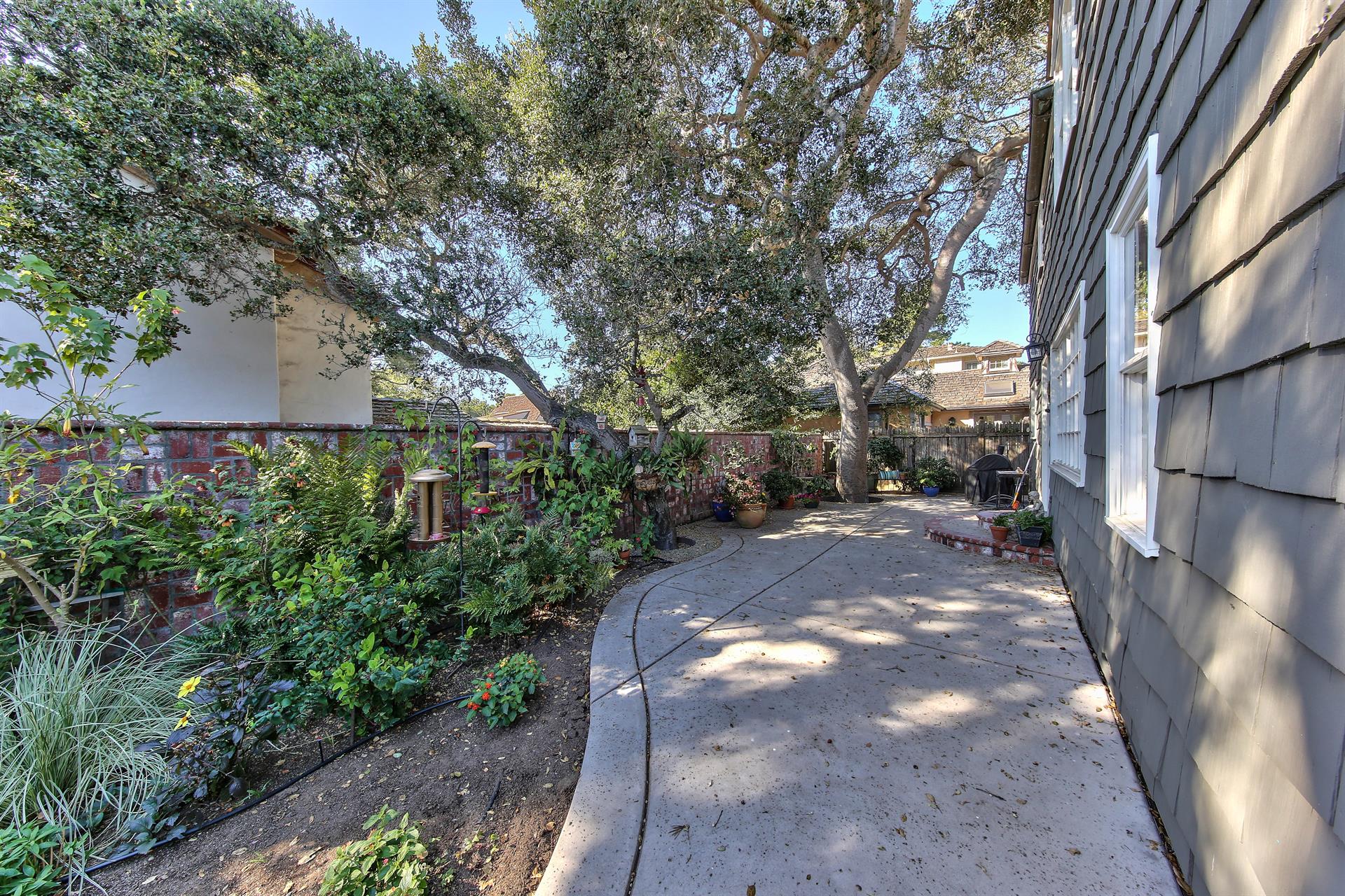 Patios and Mature Landscaping Surround the Home