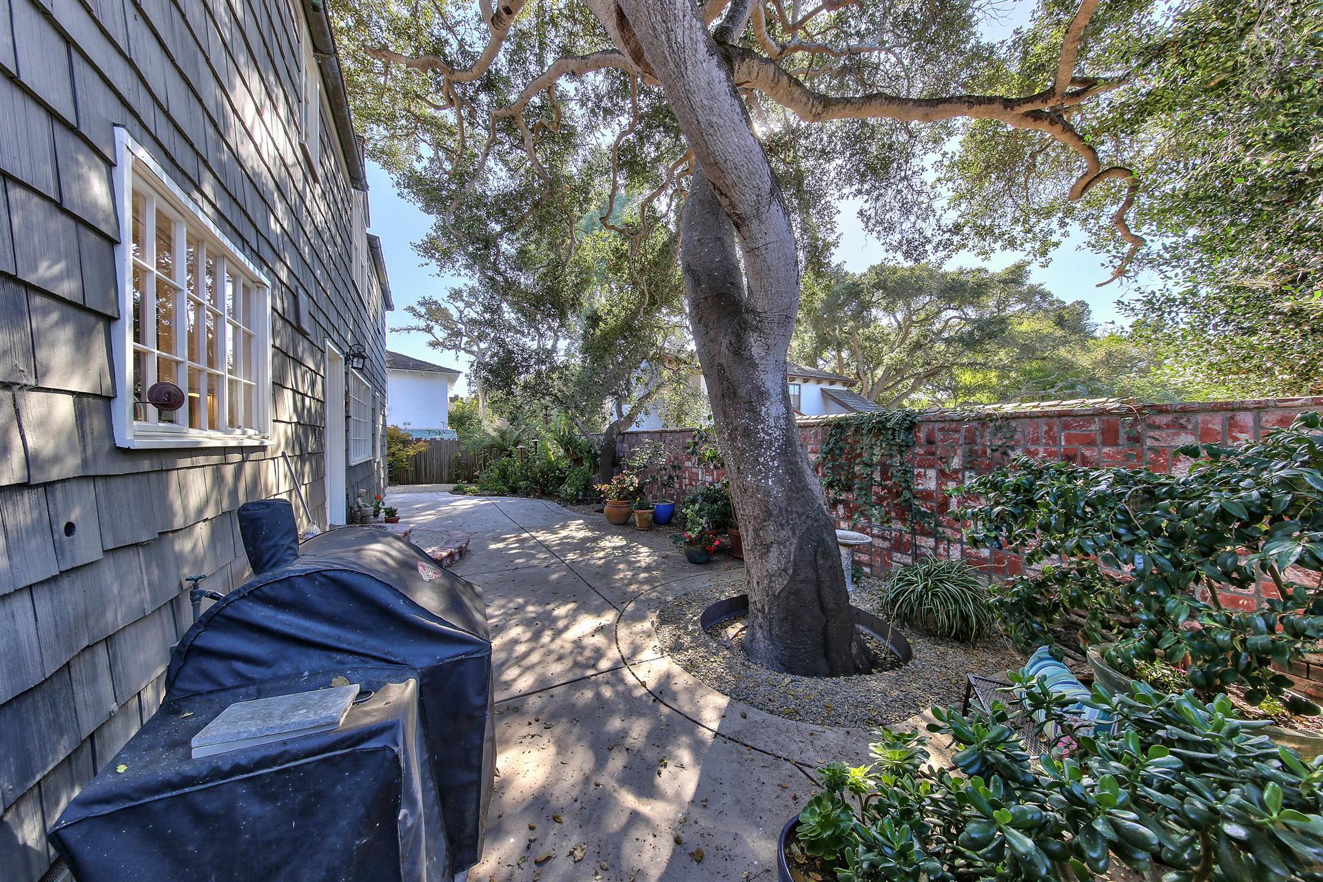 Patios and Mature Landscaping Surround the Home