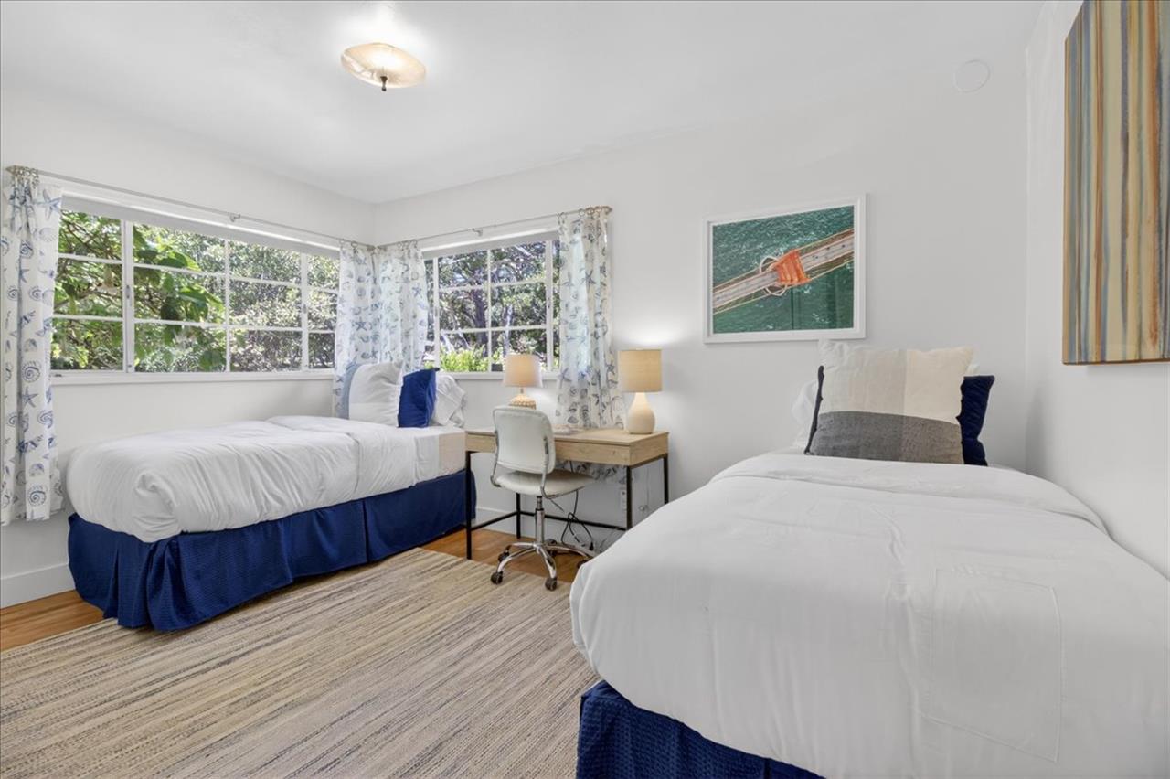 Bedroom 2 has Twin Beds and a Desk for Remote Work