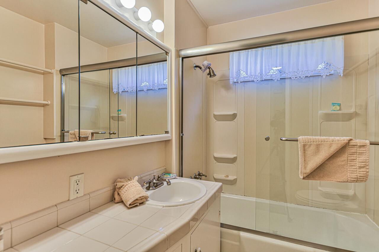Full Hall Bathroom with ShowerOverTub and Glass Doors