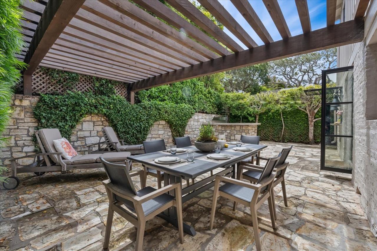 Backyard Patio has an Outdoor Kitchen with a Gas Grill