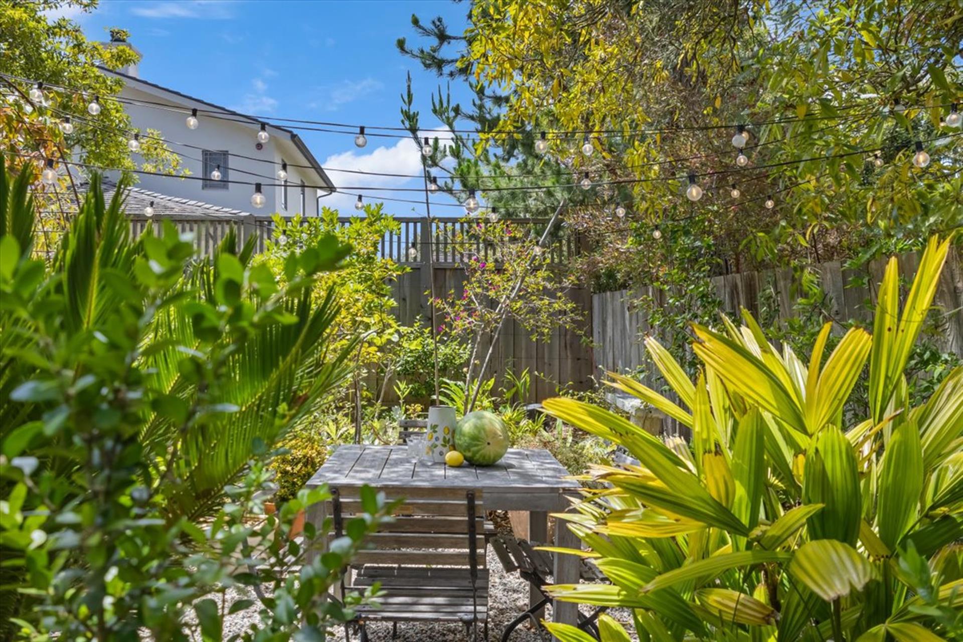 Backyard has a Gas Grill and Dining Area