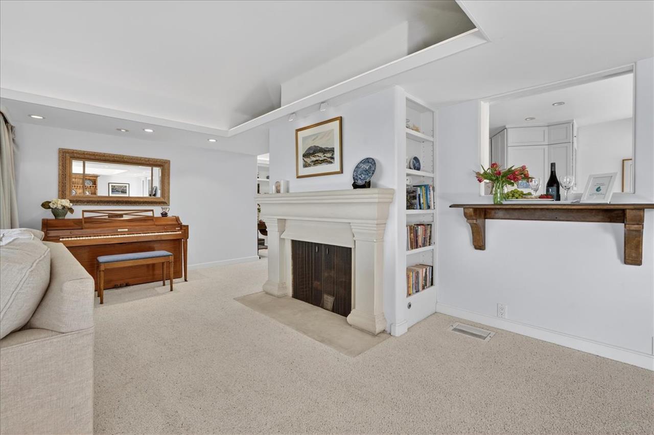 Living Room has a Decorative Only Fireplace and Piano