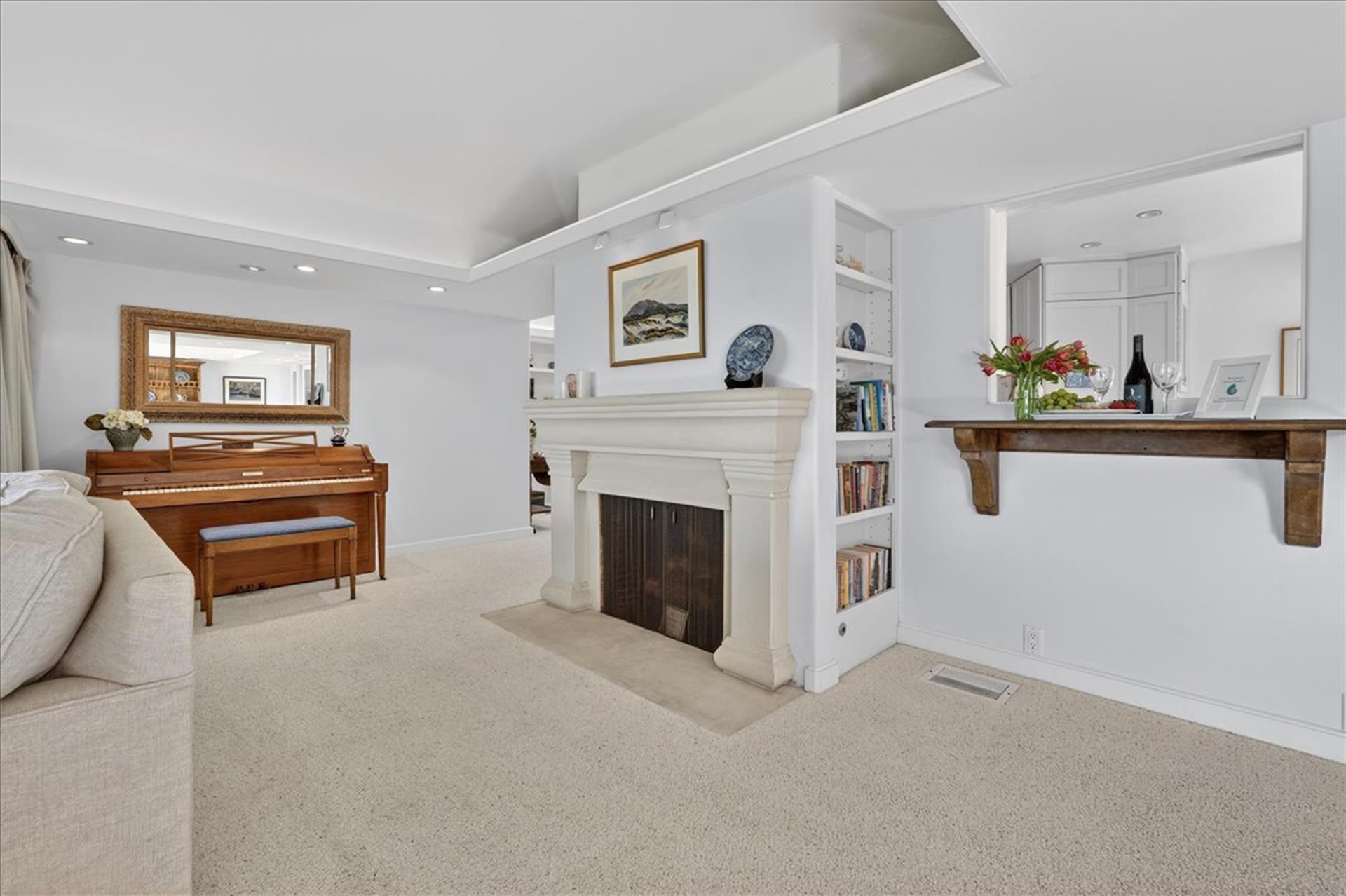 Living Room has a Decorative Only Fireplace and Piano