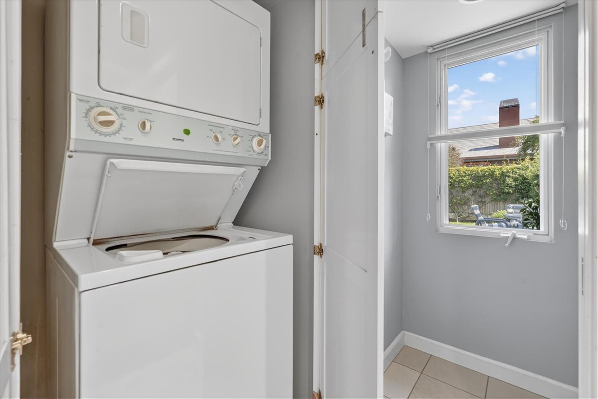 A Stacked Washer  Dryer is in the Home