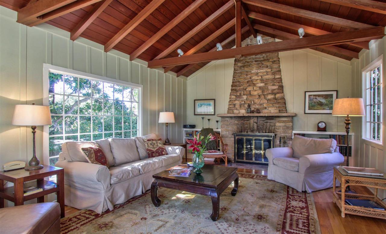 Inviting Living Room with Wood Burning Fireplace, Garden Views