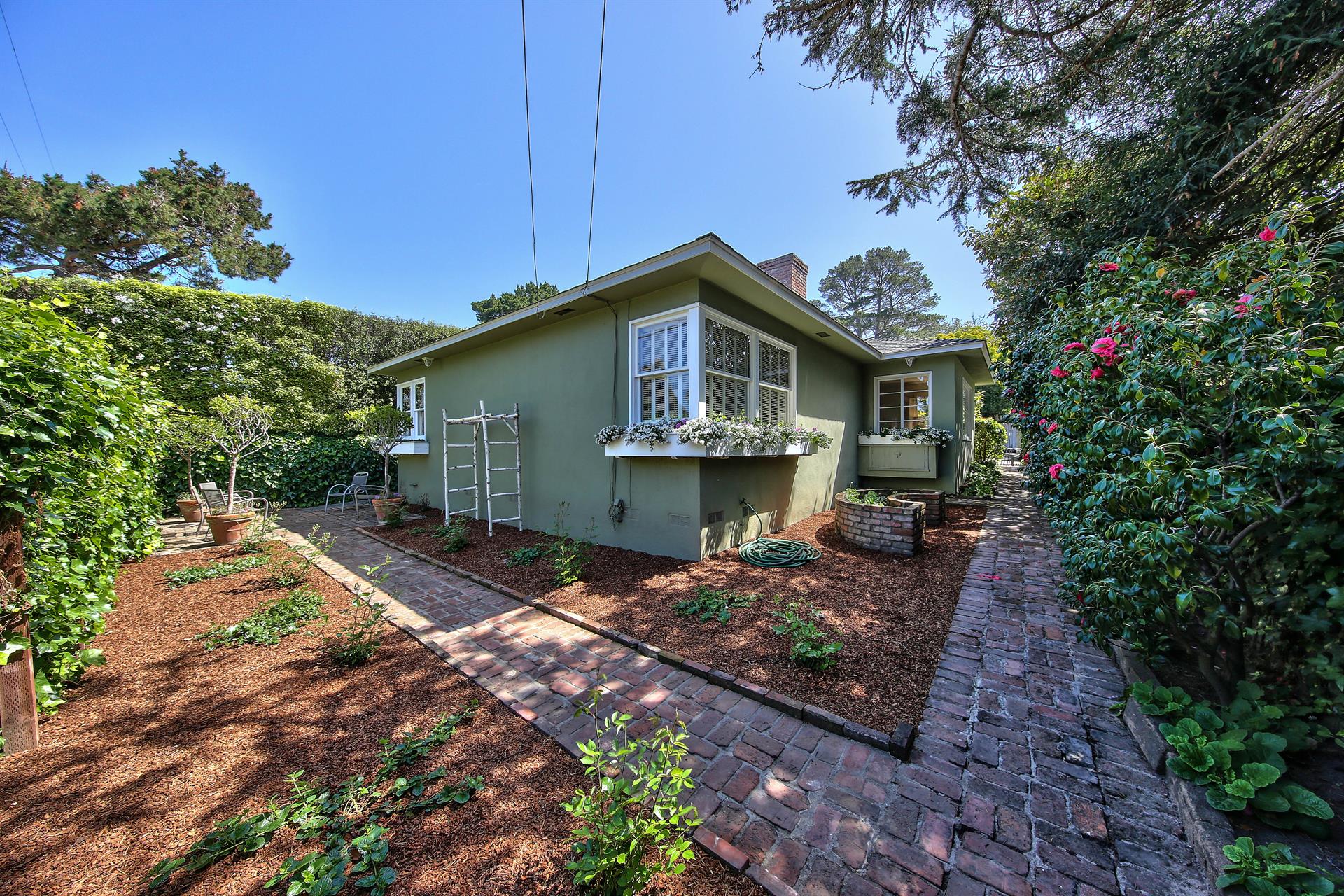 A Sweet Garden and Mature Hedges Surround the Home