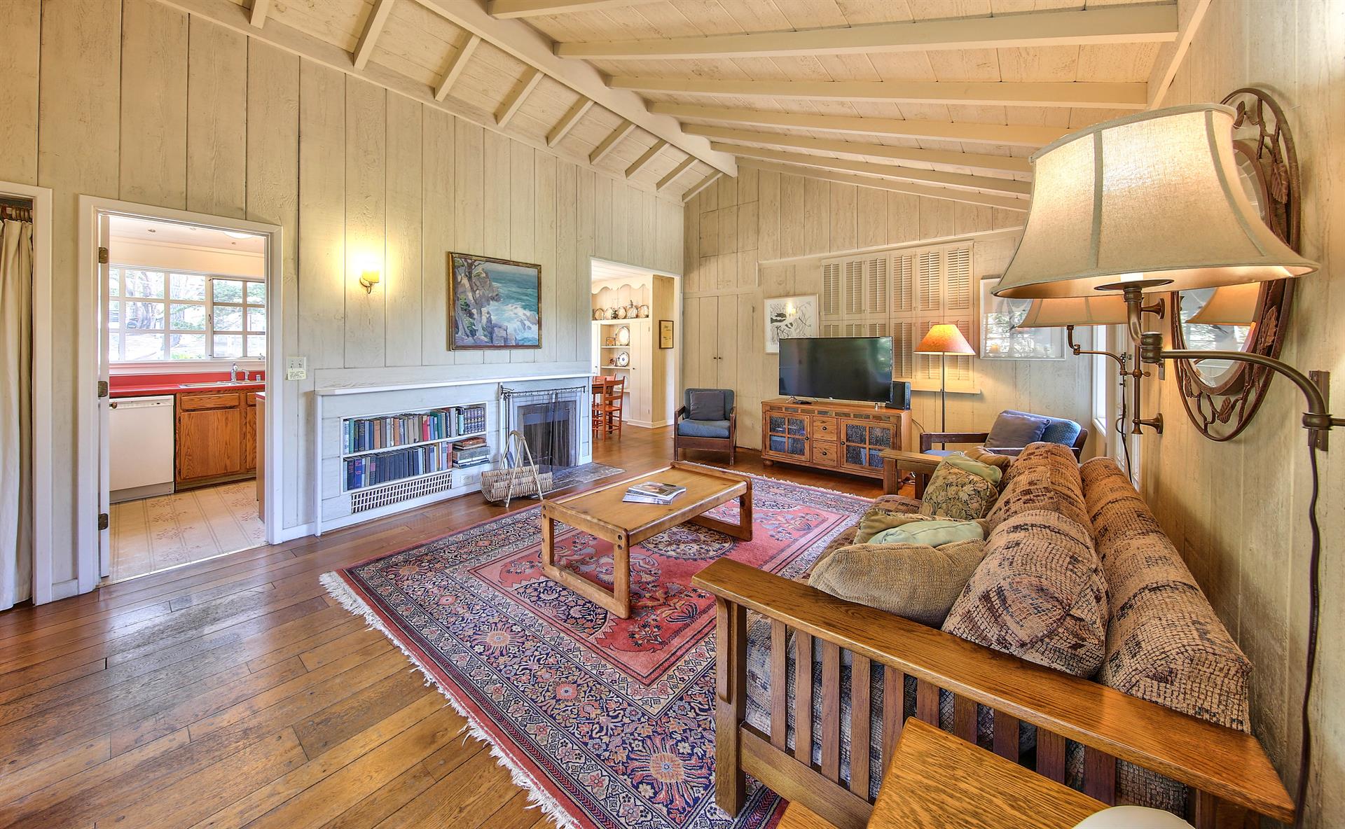 Living Room with TV, Wood Burning Fireplace and Vaulted Ceiling