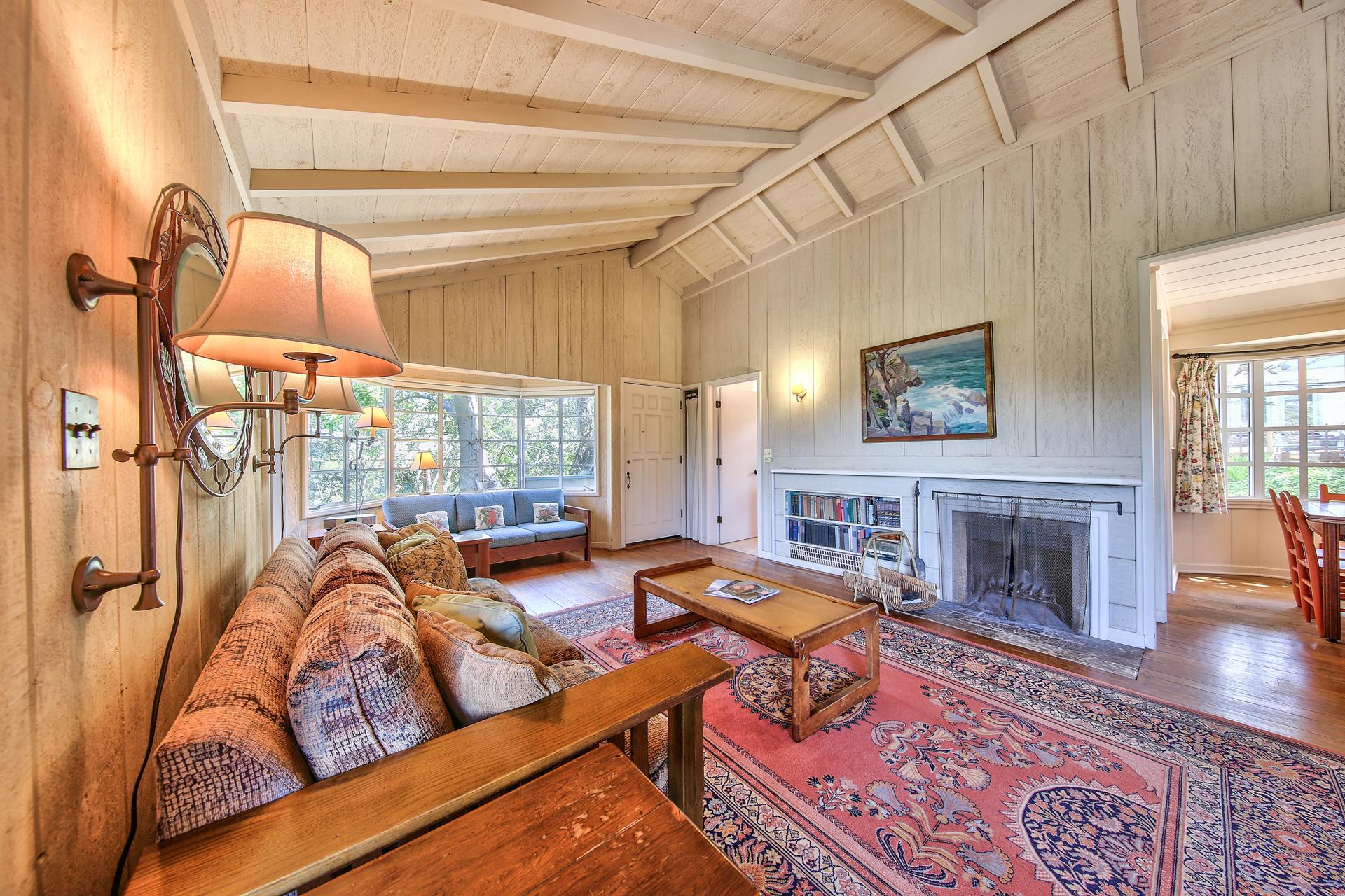 Living Room with TV, Wood Burning Fireplace and Vaulted Ceiling