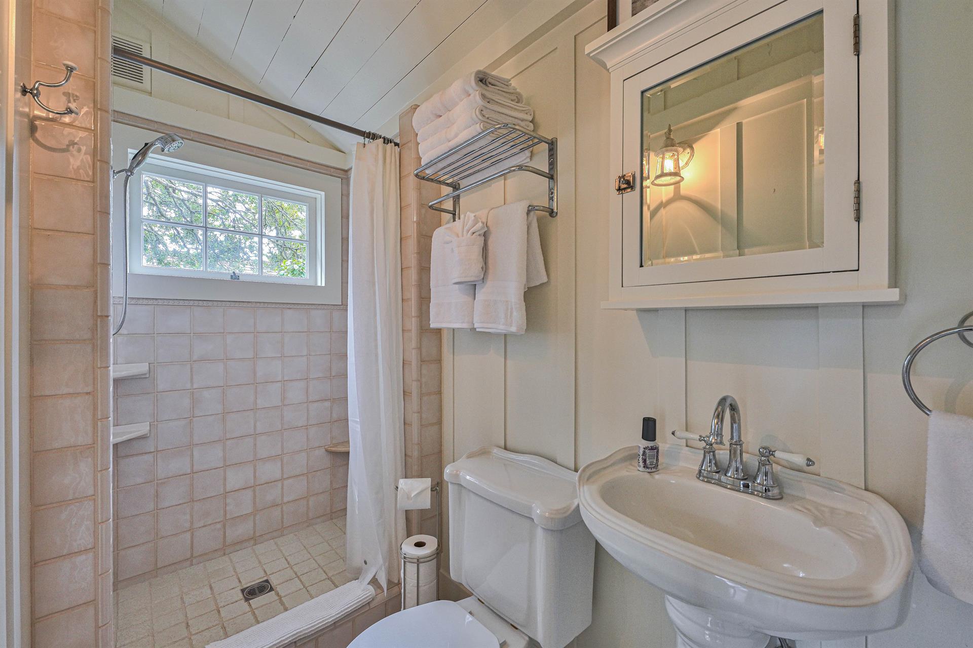 Full Hall Bathroom with Shower and Stacked Washer and Dryer