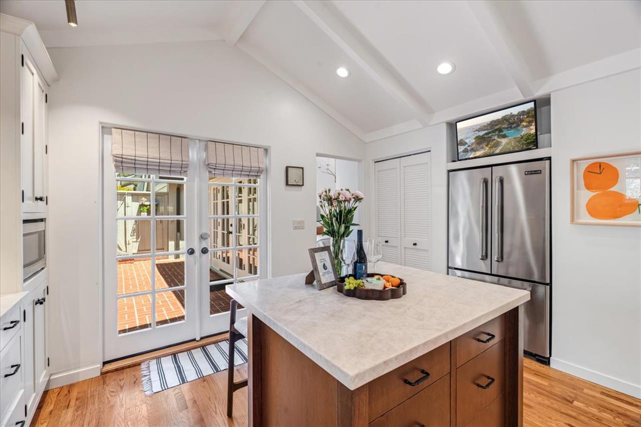Kitchen has a Smart TV Above the Refrigerator