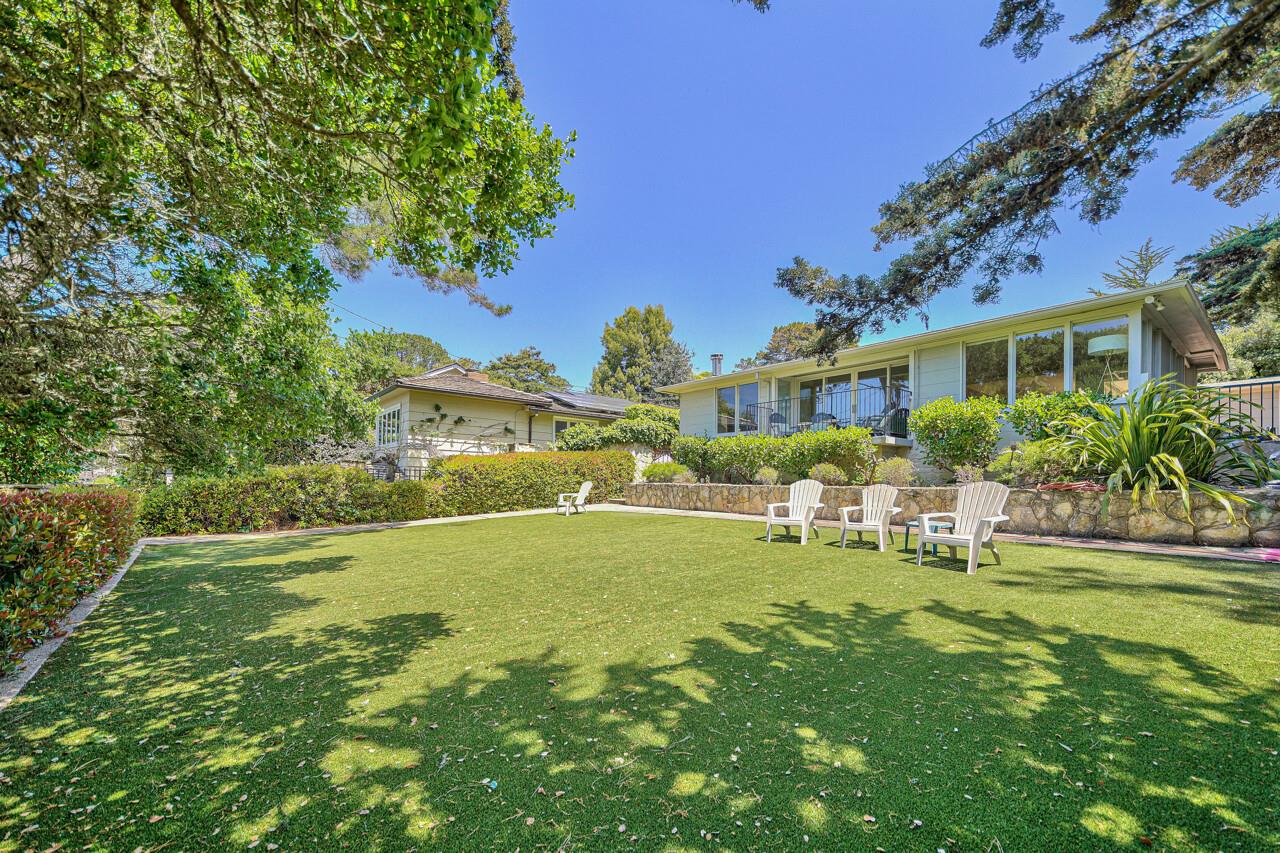 A Stone Wall and Mature Landscaping Enclose the Large Yard
